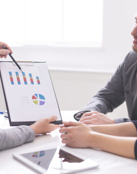 Financial advisor showing payments plan to young couple